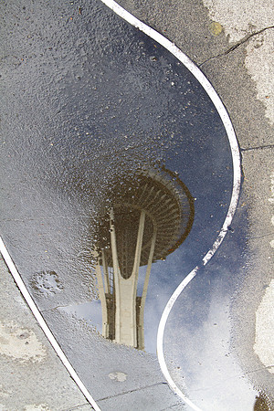 Space Needle Reflected In Puddle
